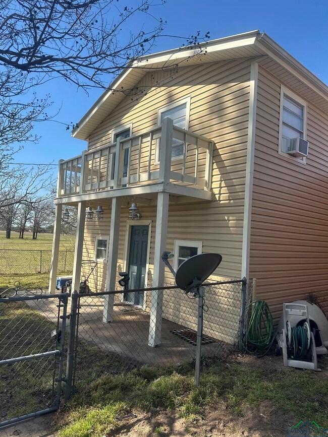 featuring a fenced front yard, a porch, a gate, a 