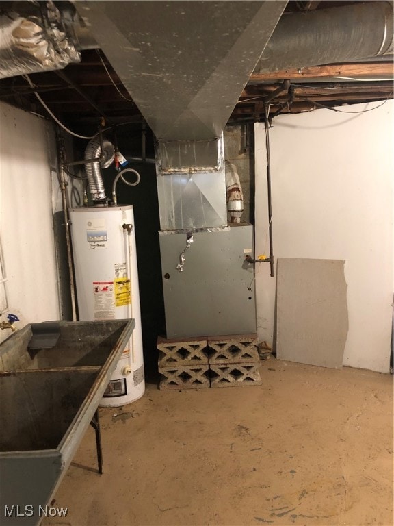 Unfinished basement featuring heating unit and water heater