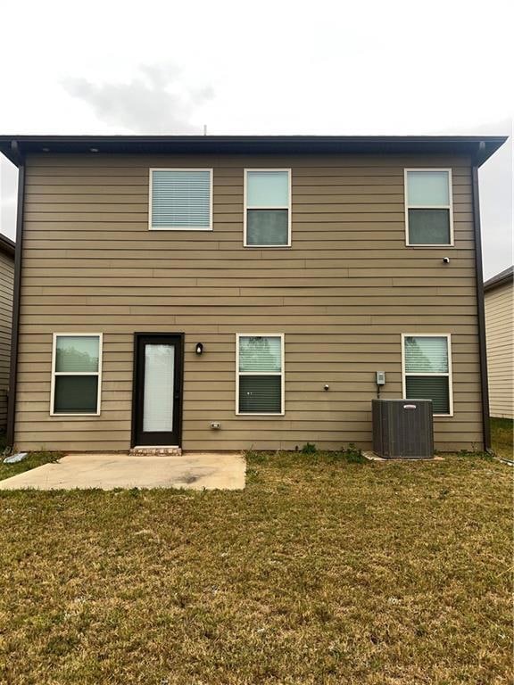 Back of house featuring a patio area and a yard