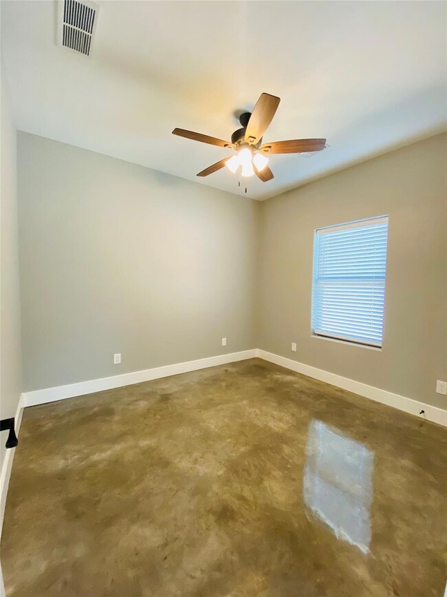 Spare room featuring concrete flooring and ceiling