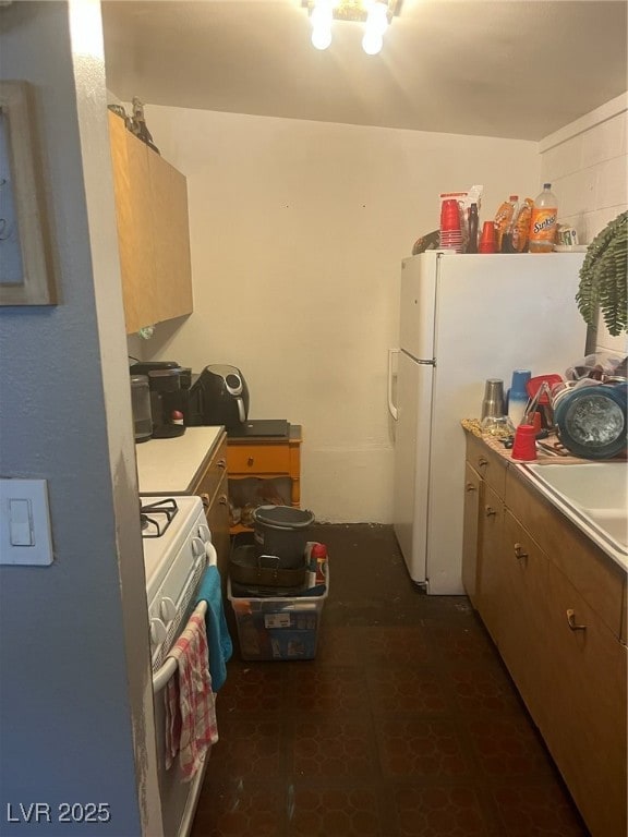 Kitchen featuring refrigerator, stove, and light c