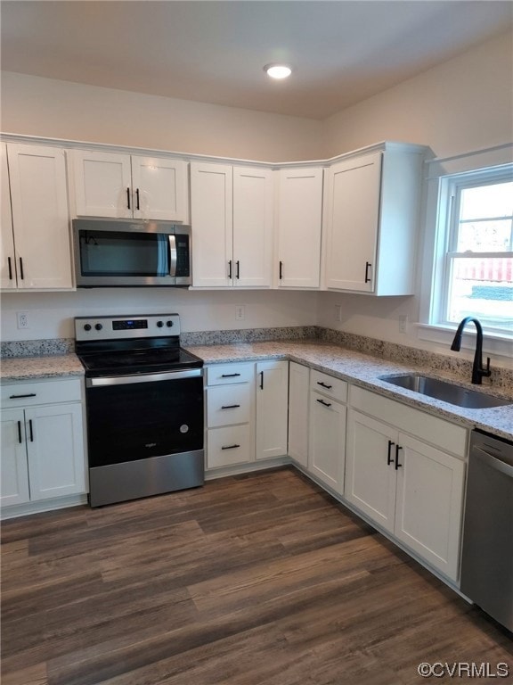 Kitchen with white cabinets, sink, dark hardwood /