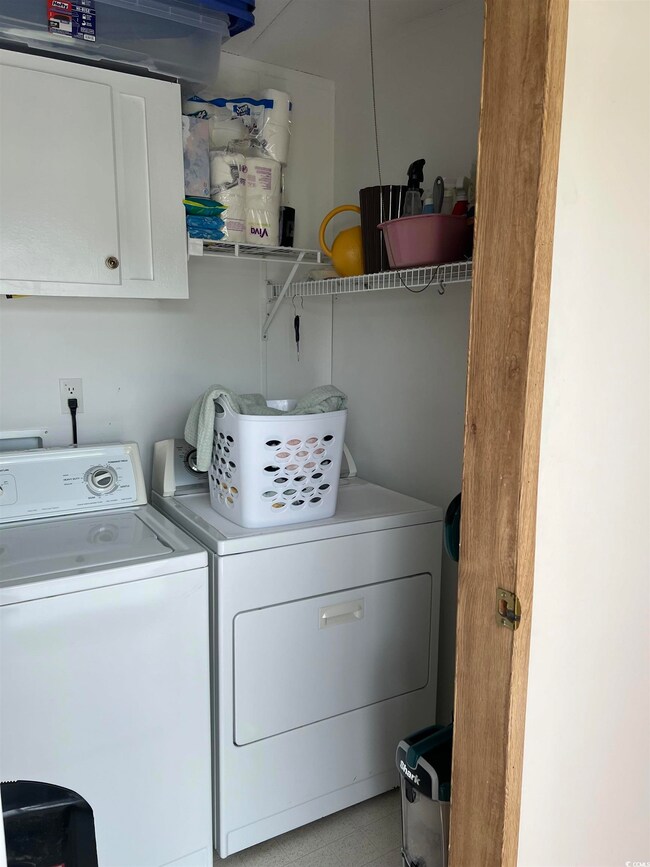 Laundry area featuring cabinets and washing machin