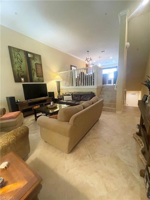 Living room with stairway and crown molding