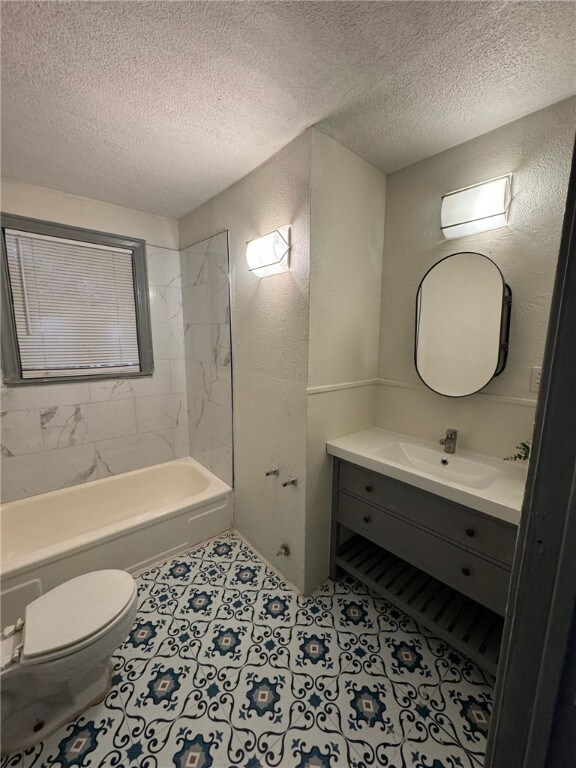 Full bathroom featuring vanity, tiled shower / bat