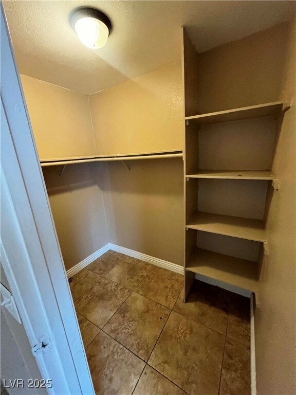 Spacious closet with tile patterned floors