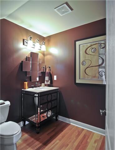 Large half bath  on main level with custom vanity & mirror.