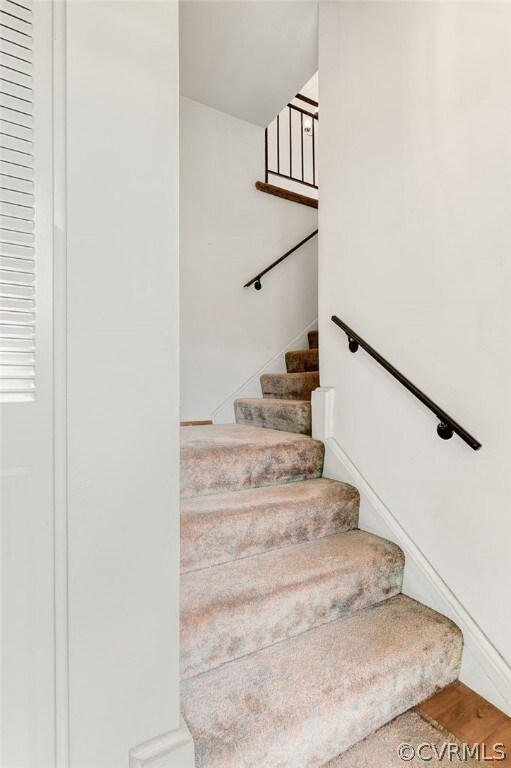 Stairway with hardwood / wood-style flooring