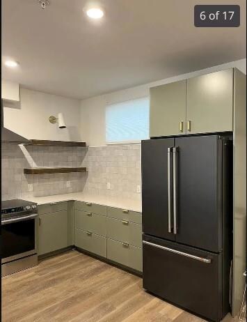 Kitchen with freestanding refrigerator, stainless