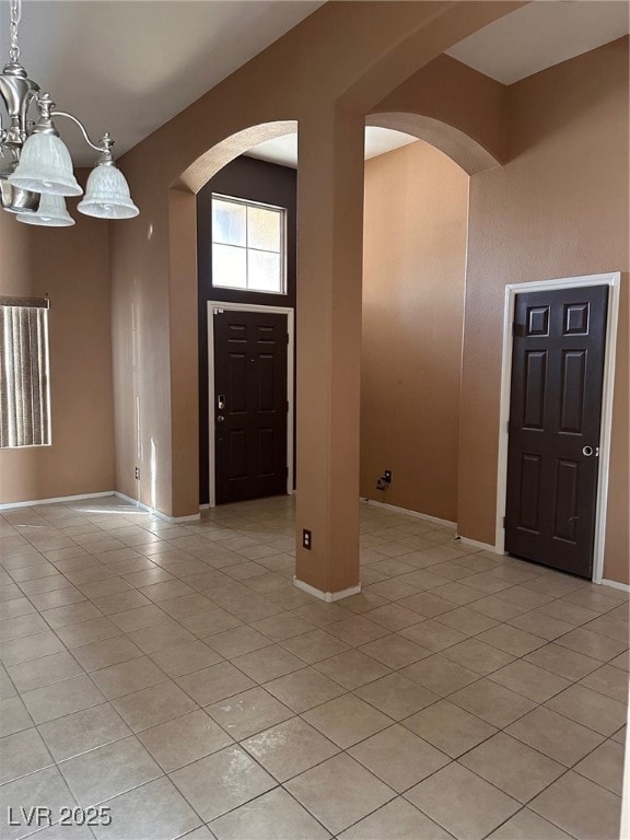 Foyer entrance with light tile patterned floors, b