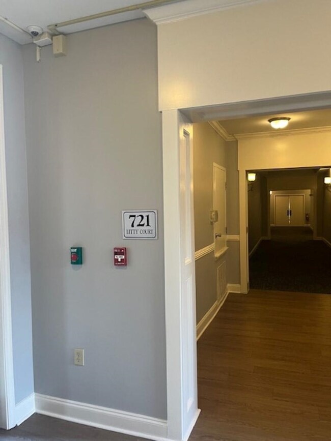 Hallway with crown molding and dark hardwood / woo