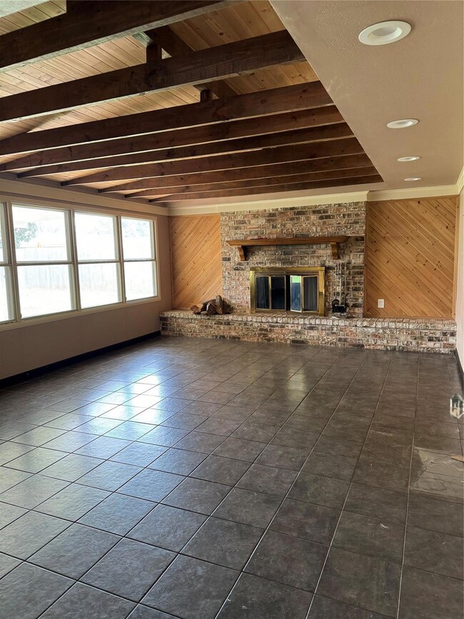 Unfurnished living room featuring dark tile floori