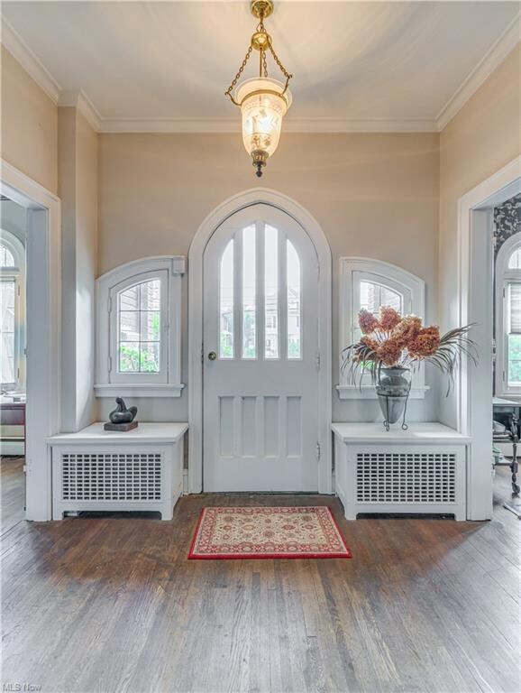 Foyer with original chandelier and hardwood floors