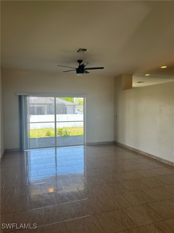 Spare room featuring baseboards and a ceiling fan