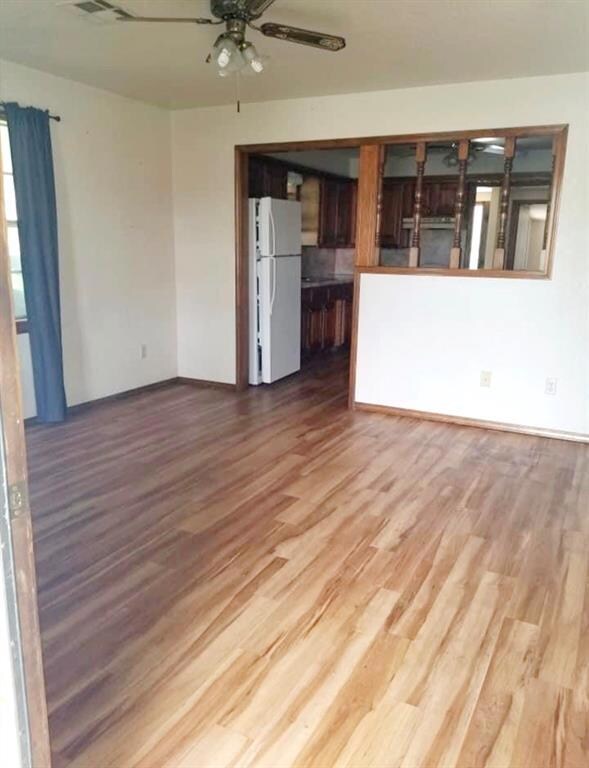 Living room with wood-type flooring and ceiling fa