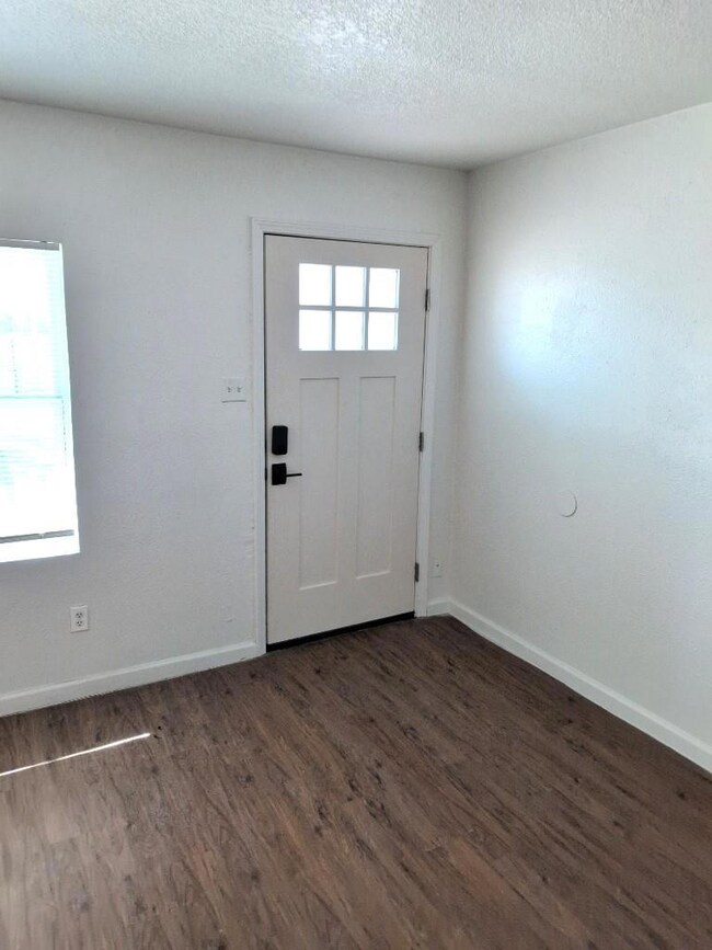 Entrance foyer with baseboards, plenty of natural