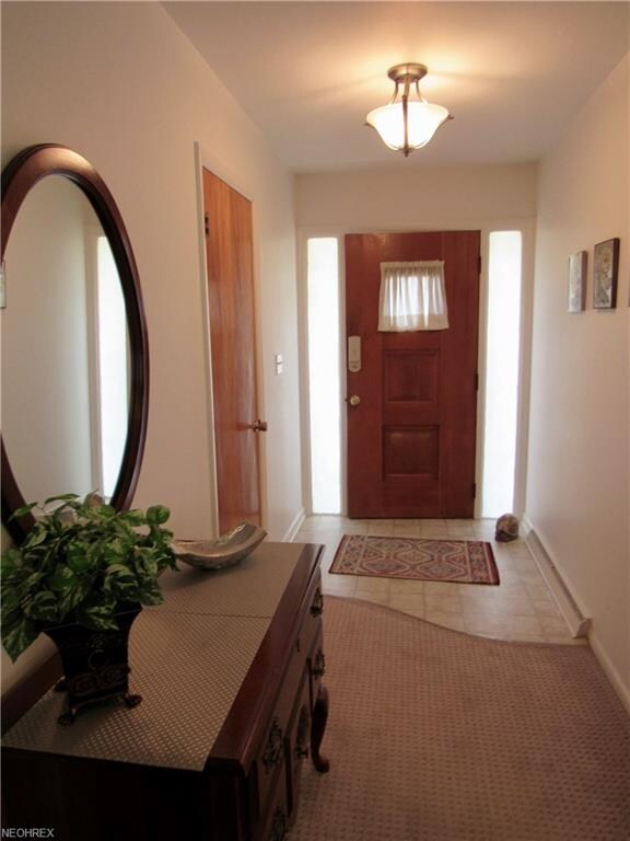 The foyer has vinyl floor and a coat closet.