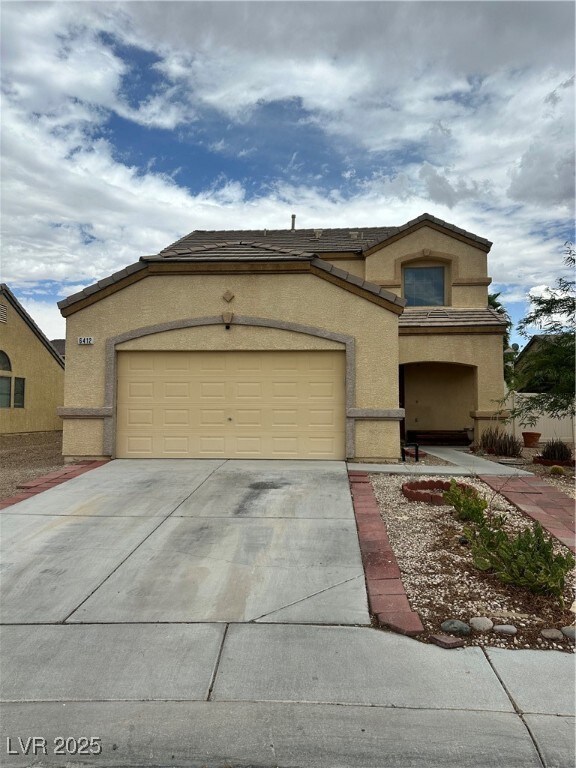 View of front of home featuring stucco siding, con