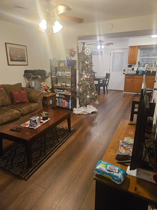 Living room with dark hardwood / wood-style floors