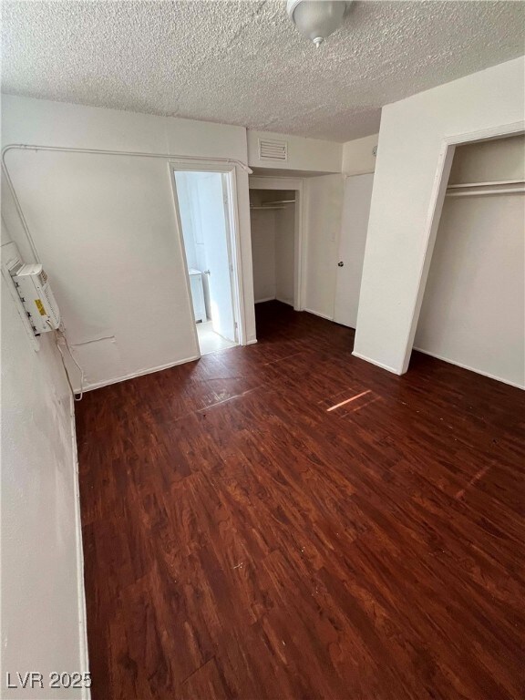 Unfurnished bedroom featuring wood finished floors