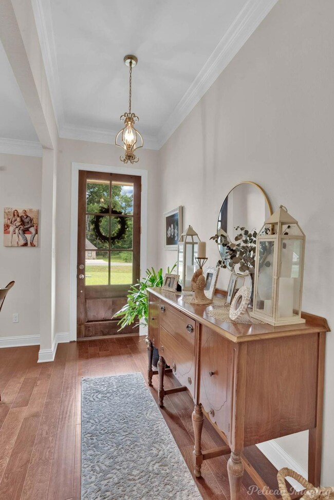 Entryway featuring crown molding and dark wood-typ