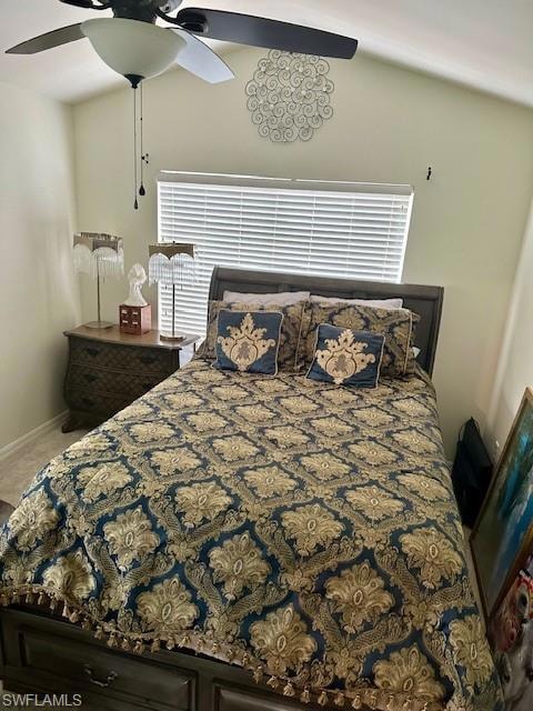 Carpeted bedroom with a ceiling fan and baseboards