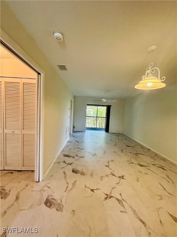 Unfurnished room with baseboards, marble finish fl