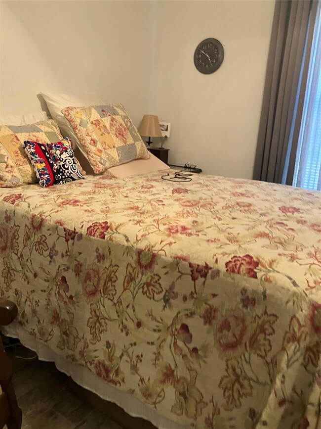 Bedroom with hardwood / wood-style flooring