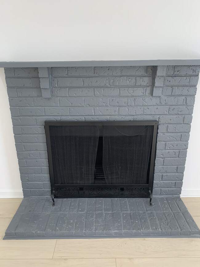 The grey brick fireplace is just another lovely update in this renovated home