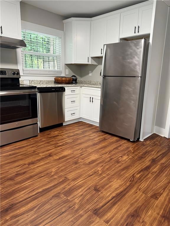 Kitchen featuring stainless steel appliances, white cabinets, dark wood-style flooring, and range hood