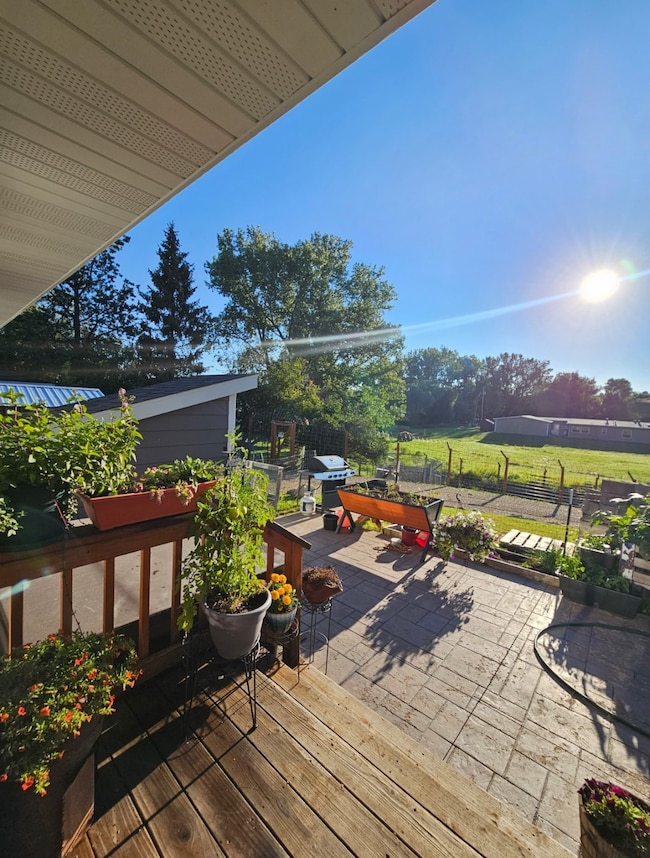 Wooden deck featuring area for grilling