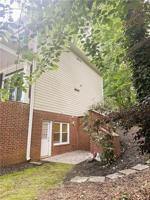 Side terrace level entry to property with a patio 
