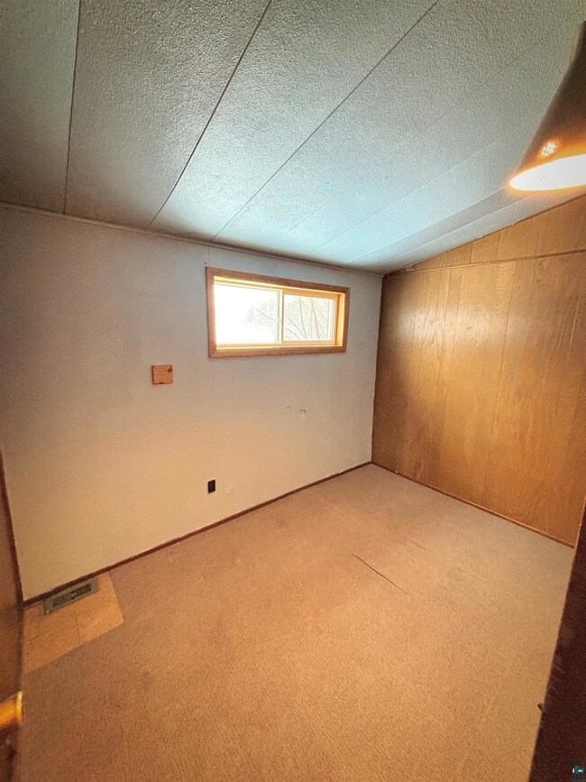 Interior space with wood walls, a textured ceiling