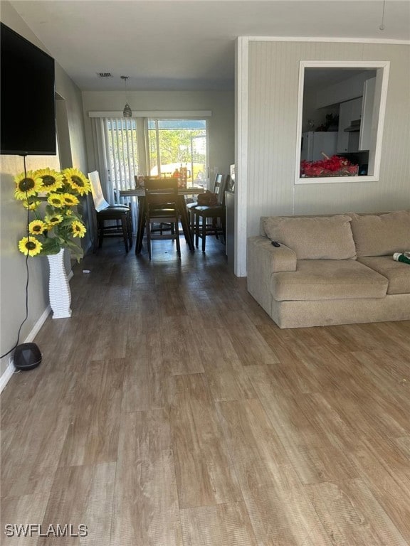Living area featuring baseboards, visible vents, a