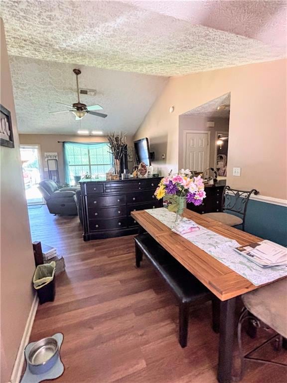 Dining area featuring a textured ceiling, wood fin
