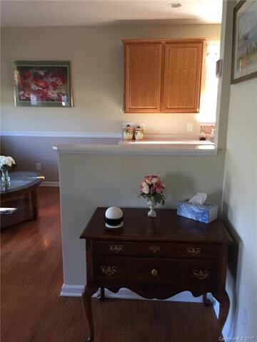 The peninsula counter opens the kitchen to the gre