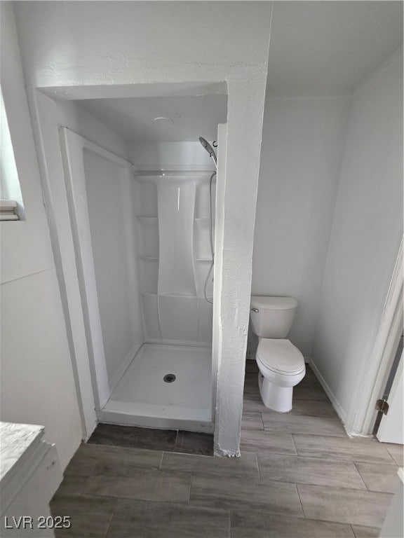 Full bathroom with a shower stall and wood finish floors
