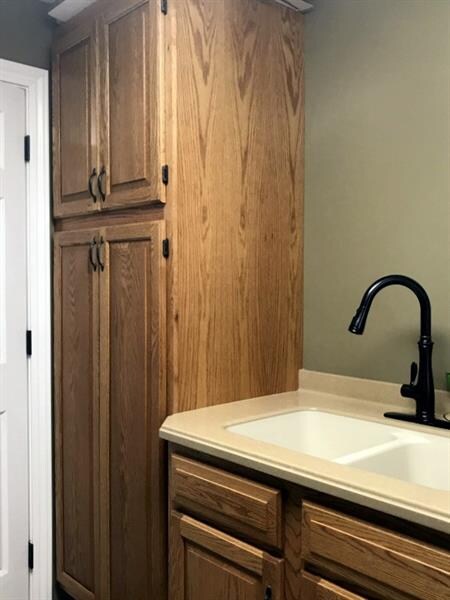 PANTRY OFF OF KITCHEN IN LAUNDRY ROOM. WITH SINK.