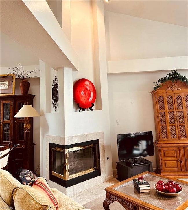 Tiled living room featuring a fireplace and a high