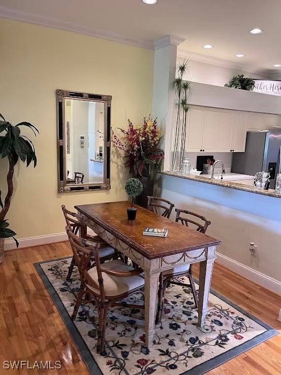 Dining space with ornamental molding, wood finishe