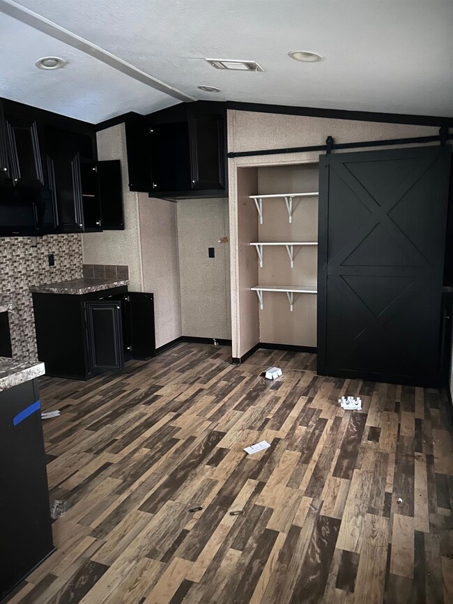 Kitchen with dark wood-type flooring, lofted ceili