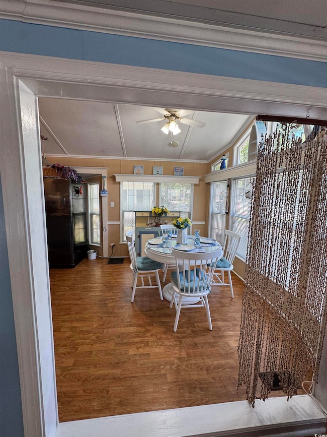 Dining room featuring crown molding, wood finished floors, and ceiling fan