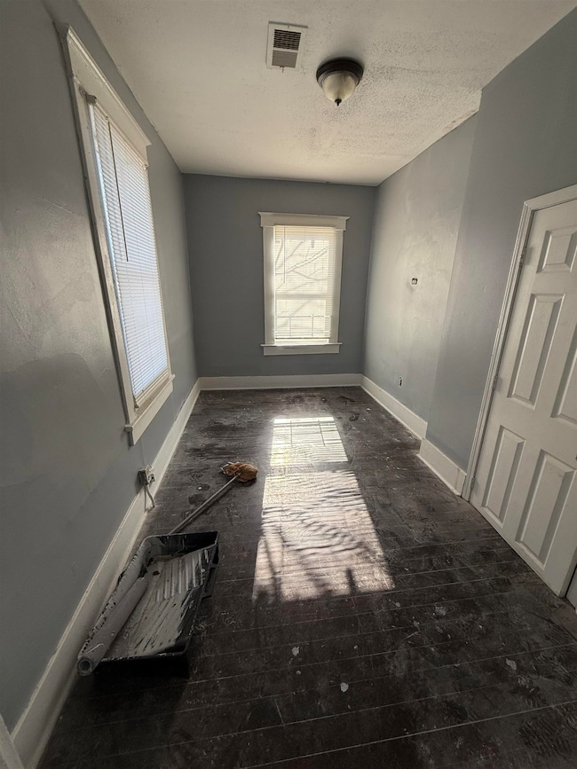Unfurnished room with a textured ceiling