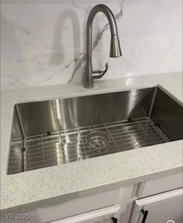 Kitchen view of light stone countertops and a sink