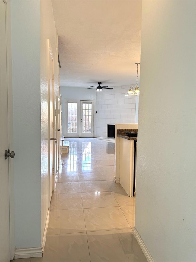 Hallway featuring light tile patterned flooring