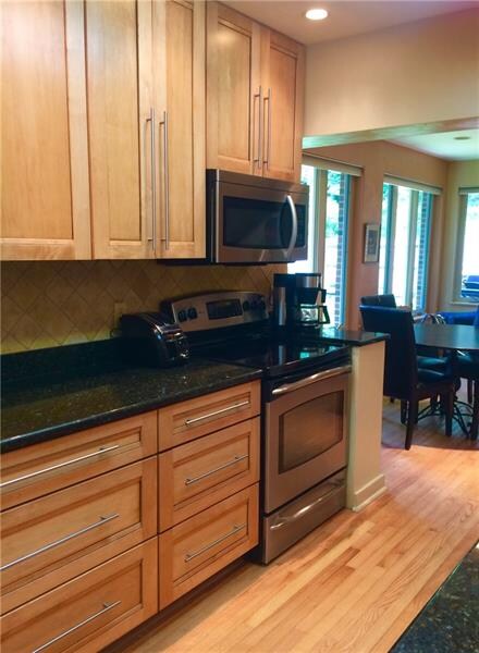 Kitchen has granite countertops and Shaker cabinet