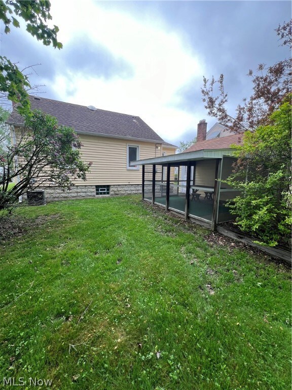 View of yard with a sunroom