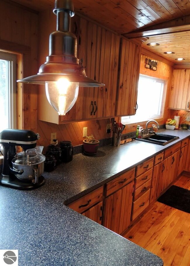 Solid surface counter tops with hickory cupboards.