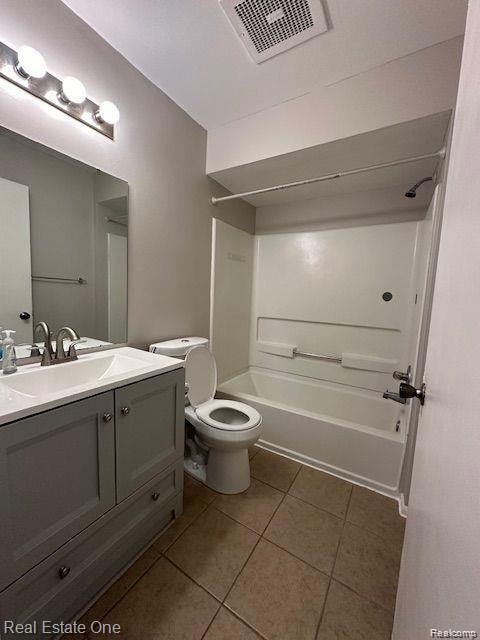 Full bath with tub / shower combination, vanity, and light tile patterned flooring