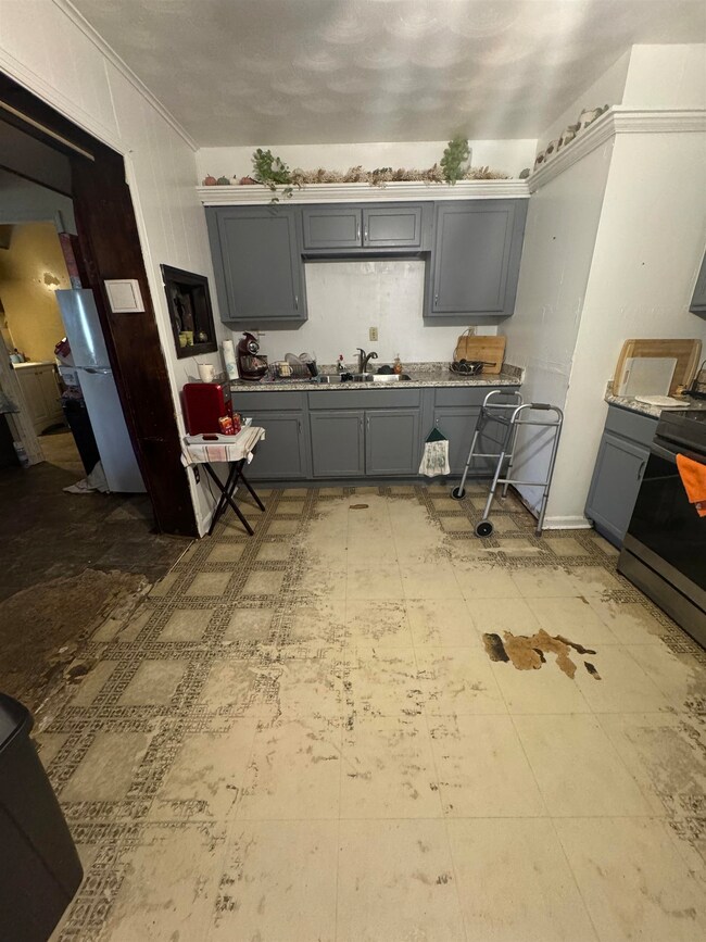 Kitchen featuring ornamental molding, sink, white 